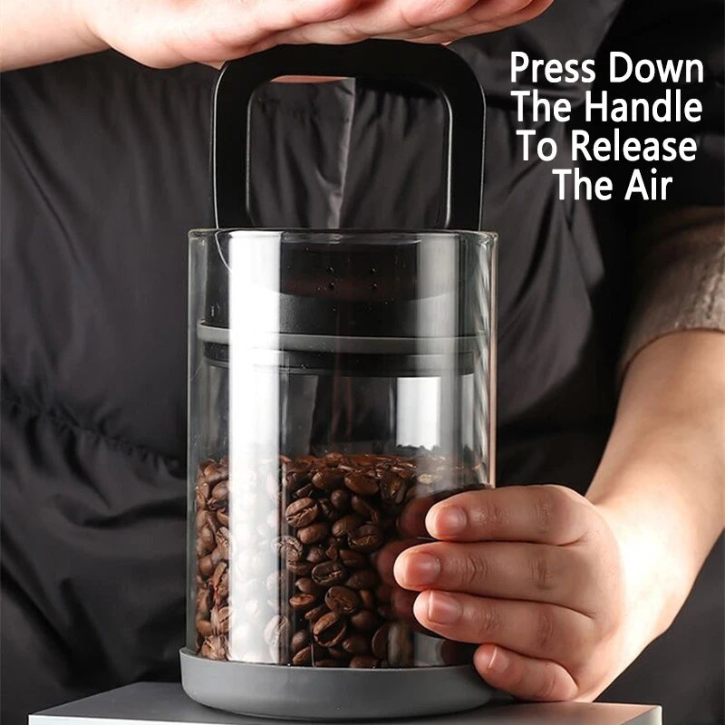 Person holding a coffee bean container with text instructing to press down the handle to release air.