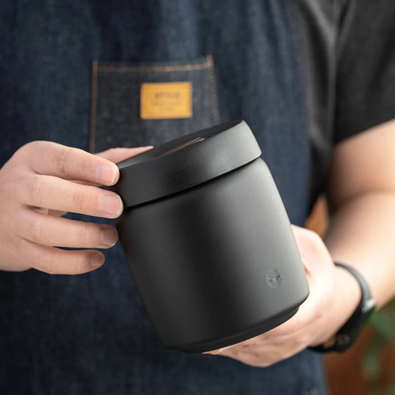 Guy holding 800ml Black Stainless Steel Airtight Vacuum Sealed Coffee Container Storage Canister